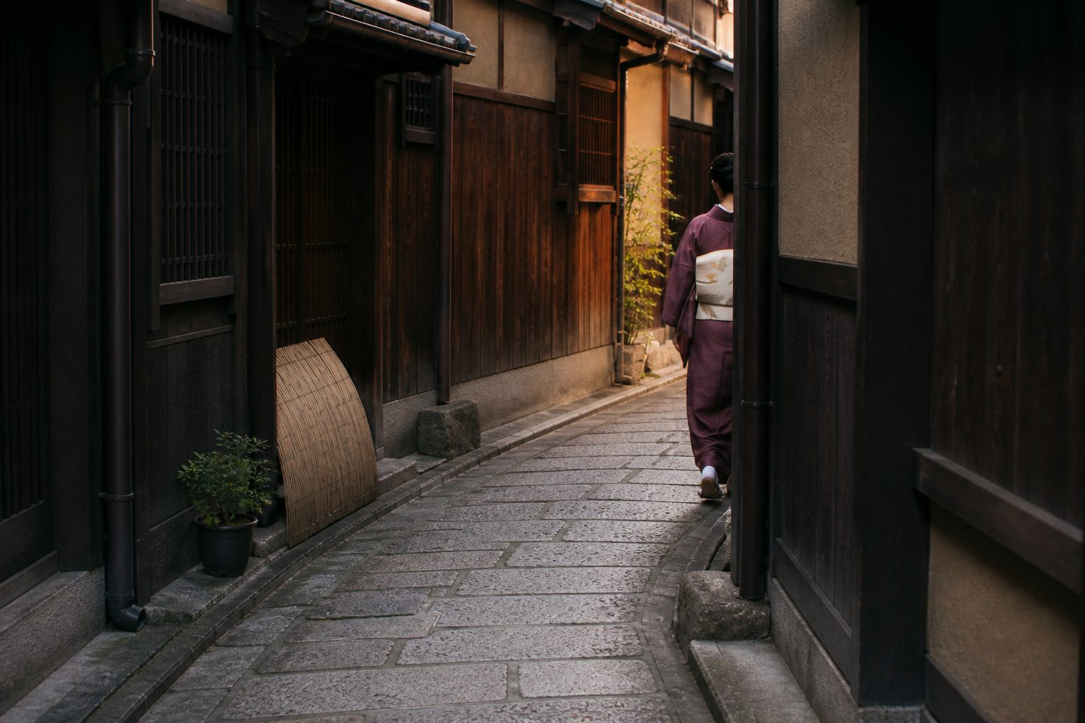 The lane bends right. The woman is half out of view, turning the corner.