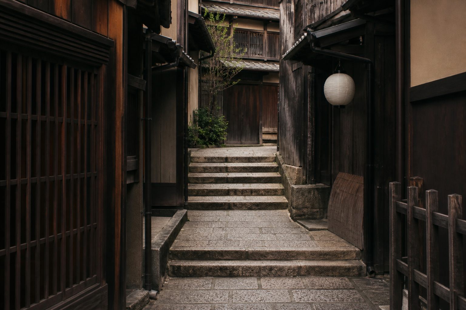 Past the bend: worn stone steps, a paper lantern not yet lit, and nobody in sight.
